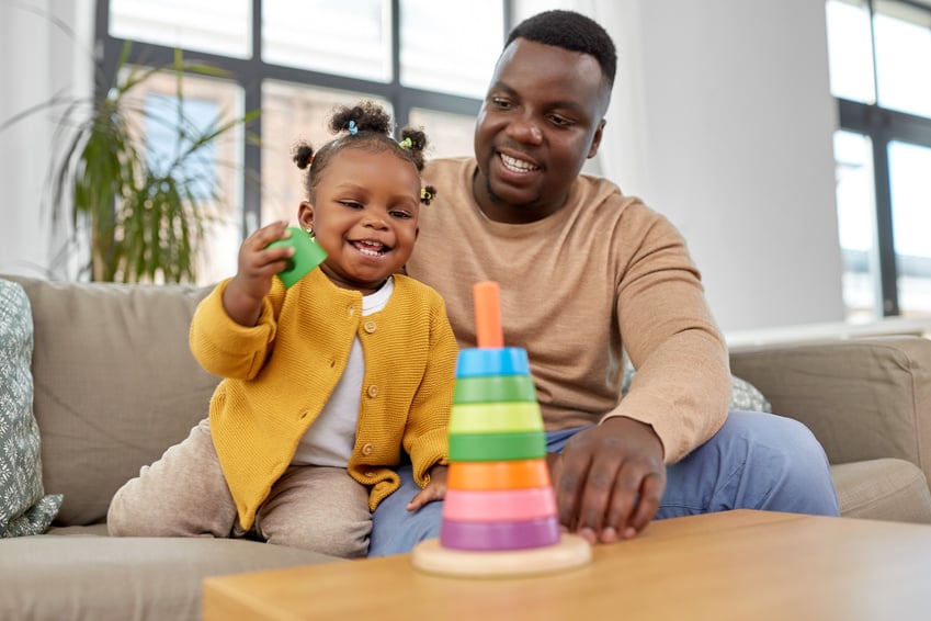 Family Playing with Baby Daughter at Home